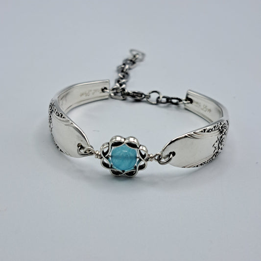 Handmade vintage silverware bracelet made from First Love 1937 pattern silverplated handles with blue bead center