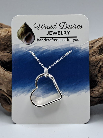 Handmade vintage silverware heart necklace made from various silverplate patterns 