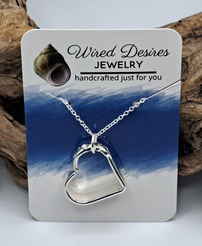 Handmade vintage silverware heart necklace made from various silverplate patterns 
