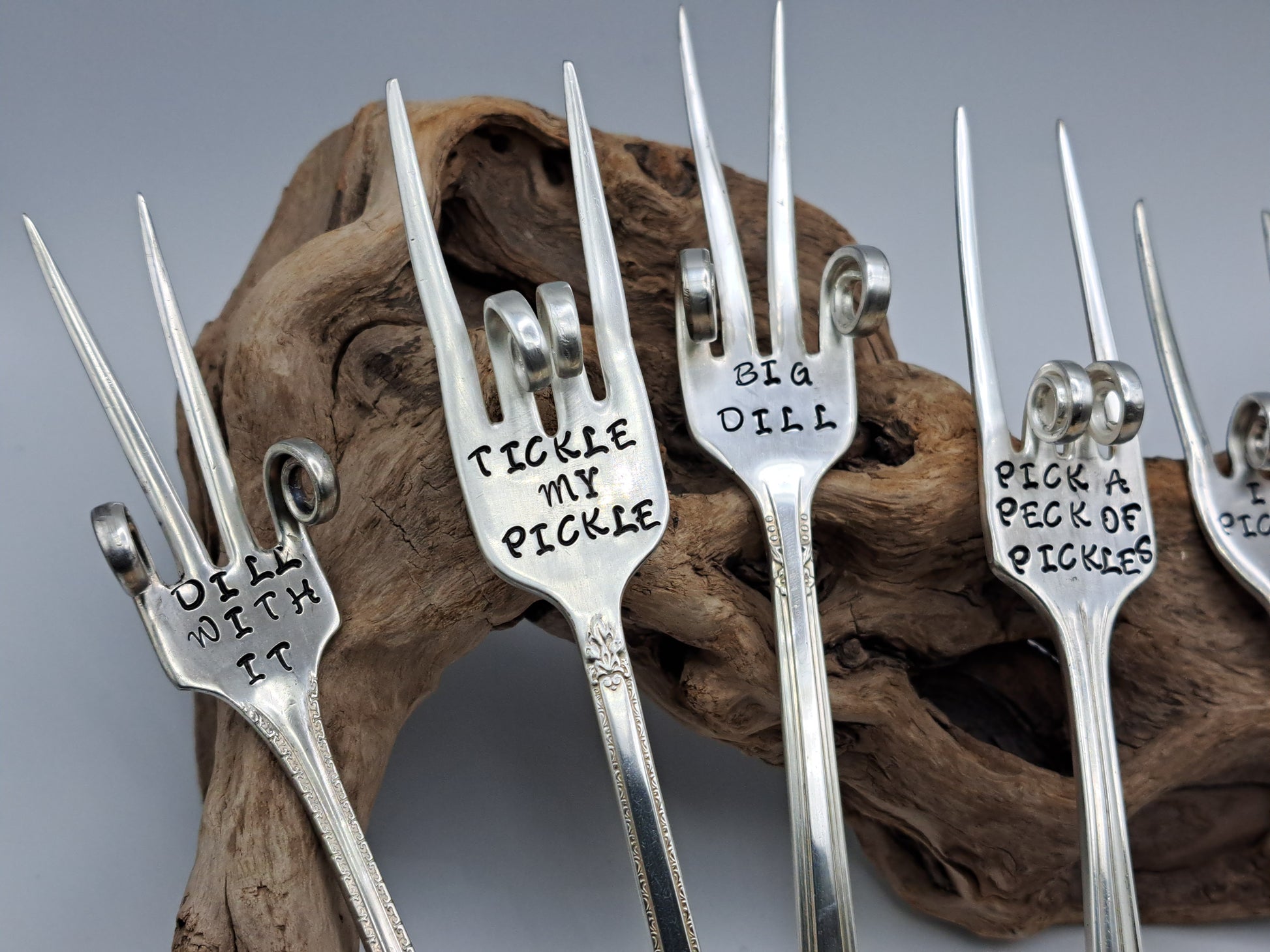 Vintage silverware forks made into pickle forks with hand-stamped expressions