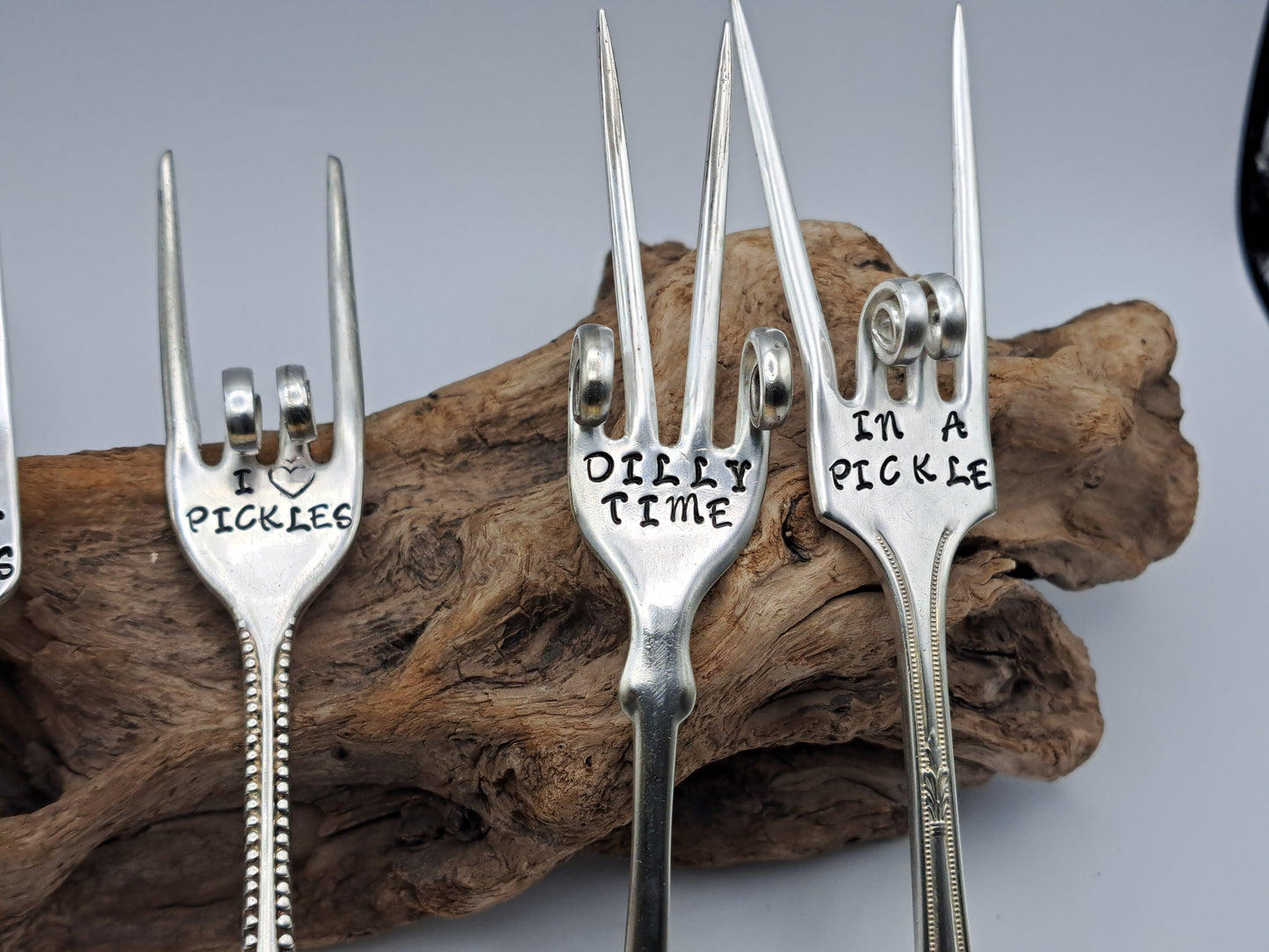 Vintage silverware forks made into pickle forks with hand-stamped expressions