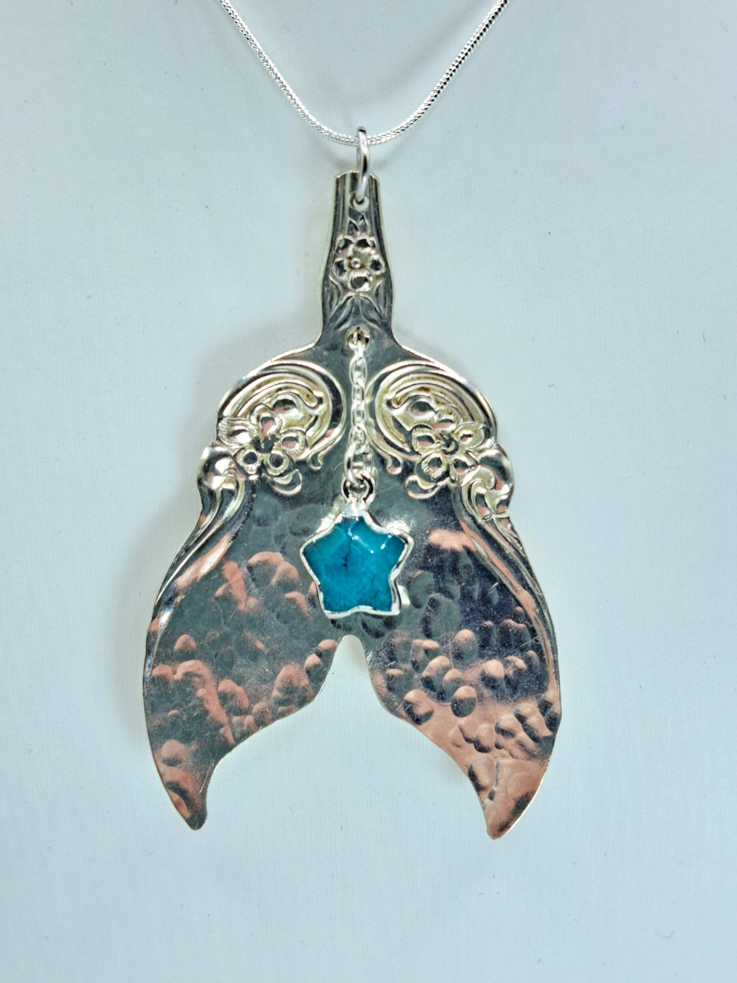 Handmade vintage silverware necklace made from Arbutus 1908 silverplate pattern shaped as a mermaid or whale tail