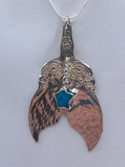 Handmade vintage silverware necklace made from Arbutus 1908 silverplate pattern shaped as a mermaid or whale tail