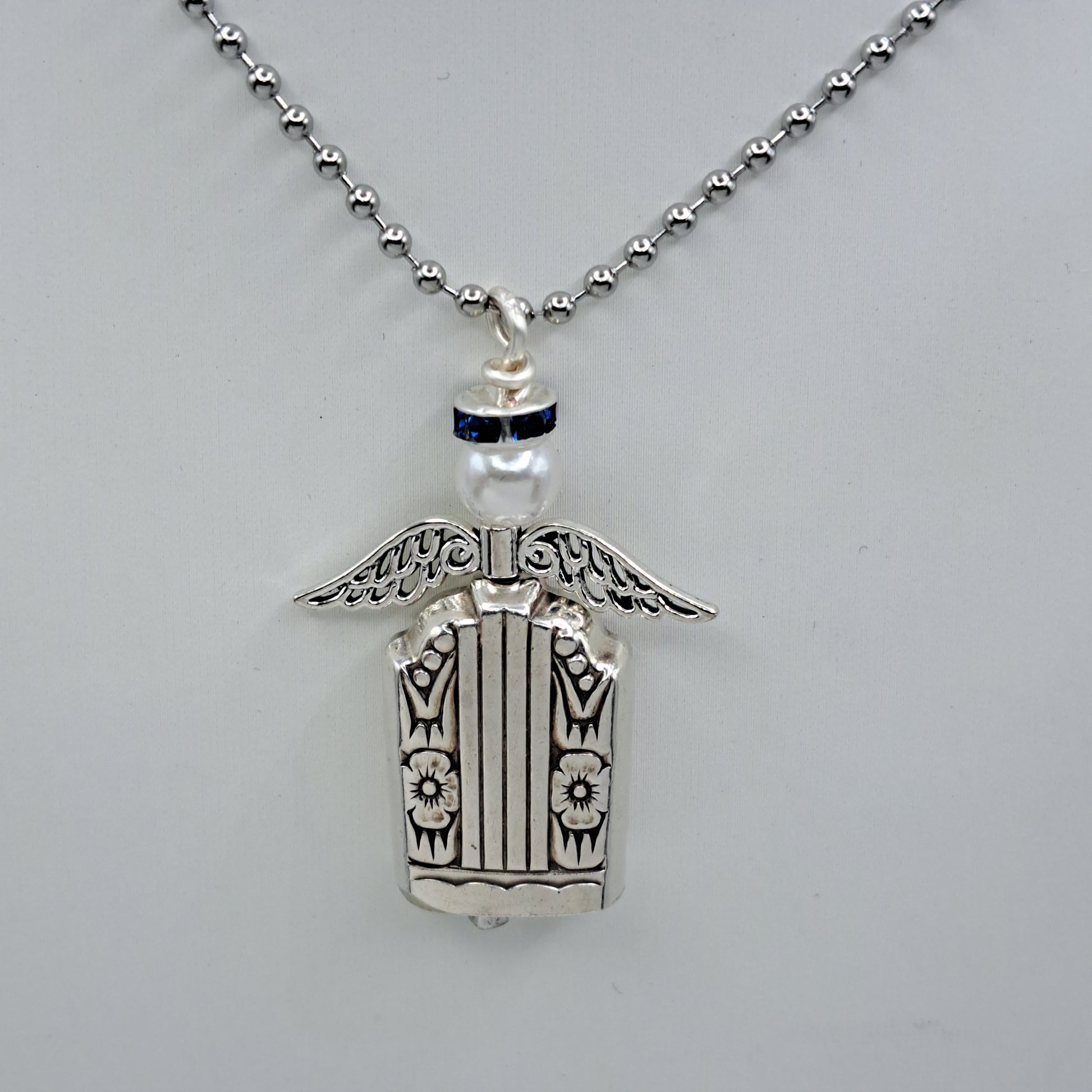 Handmade vintage silverware necklace made from Harmony 1938 silverplate into an angel bell with blue halo 