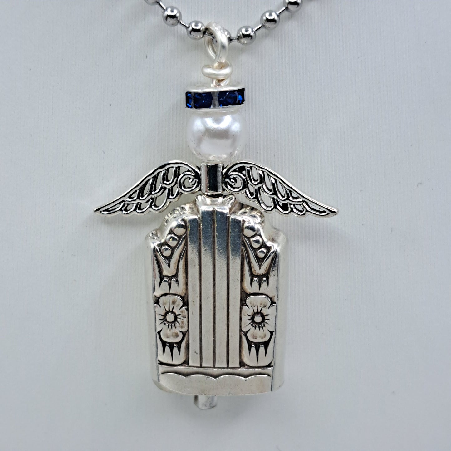 Handmade vintage silverware necklace made from Harmony 1938 silverplate into an angel bell with blue halo 