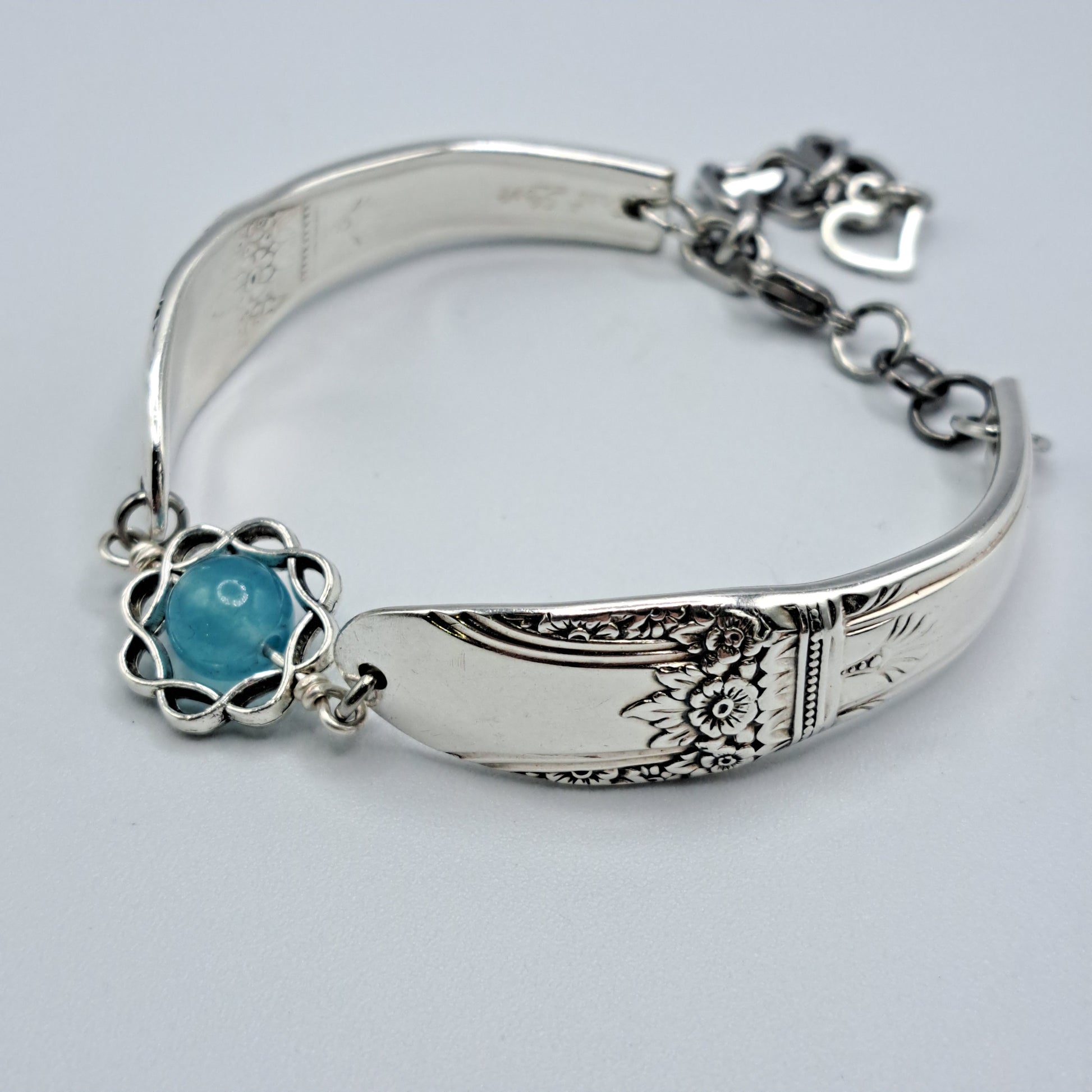 Handmade vintage silverware bracelet made from First Love 1937 pattern silverplated handles with blue bead center