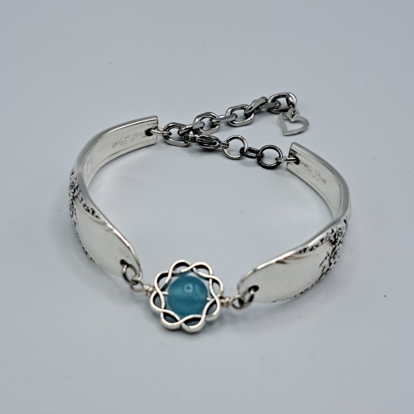 Handmade vintage silverware bracelet made from First Love 1937 pattern silverplated handles with blue bead center
