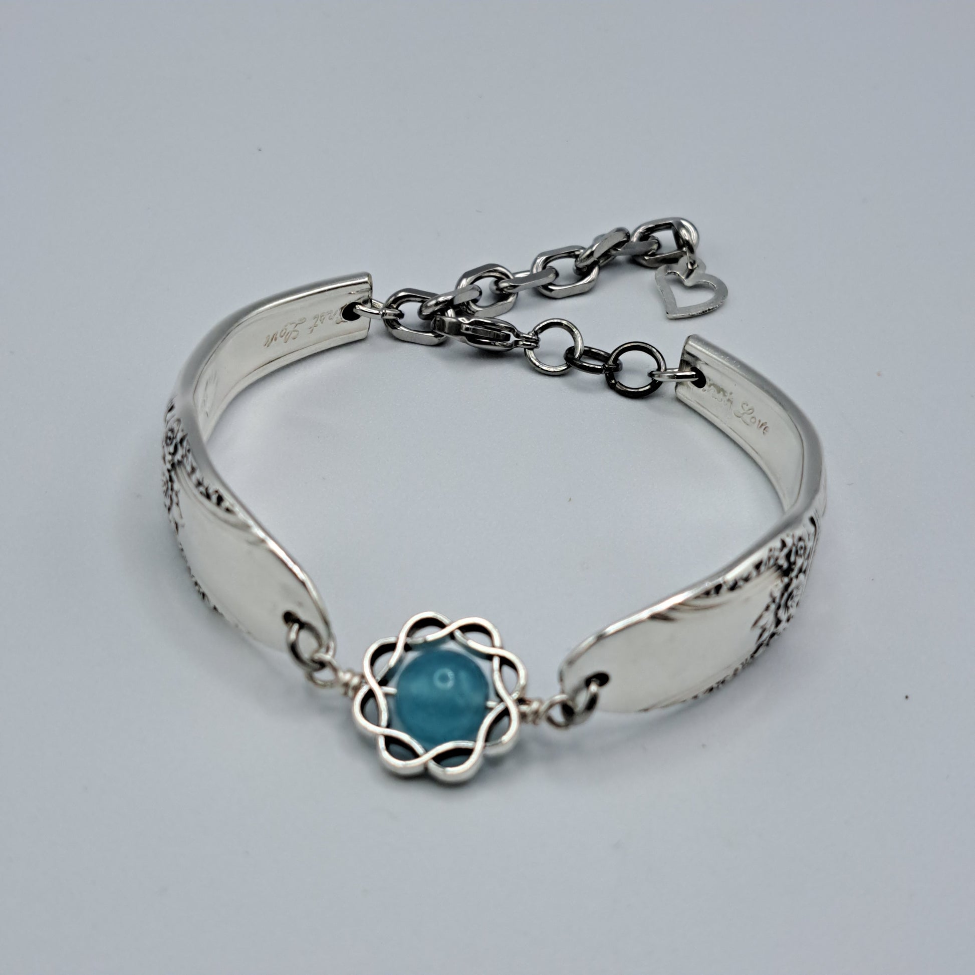 Handmade vintage silverware bracelet made from First Love 1937 pattern silverplated handles with blue bead center