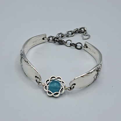 Handmade vintage silverware bracelet made from First Love 1937 pattern silverplated handles with blue bead center