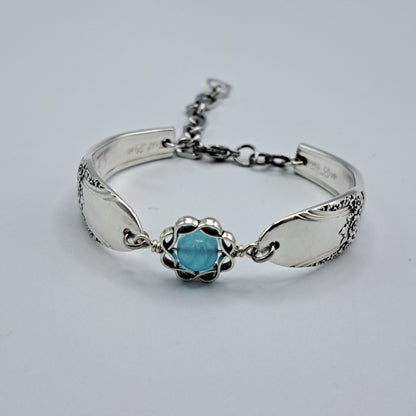 Handmade vintage silverware bracelet made from First Love 1937 pattern silverplated handles with blue bead center