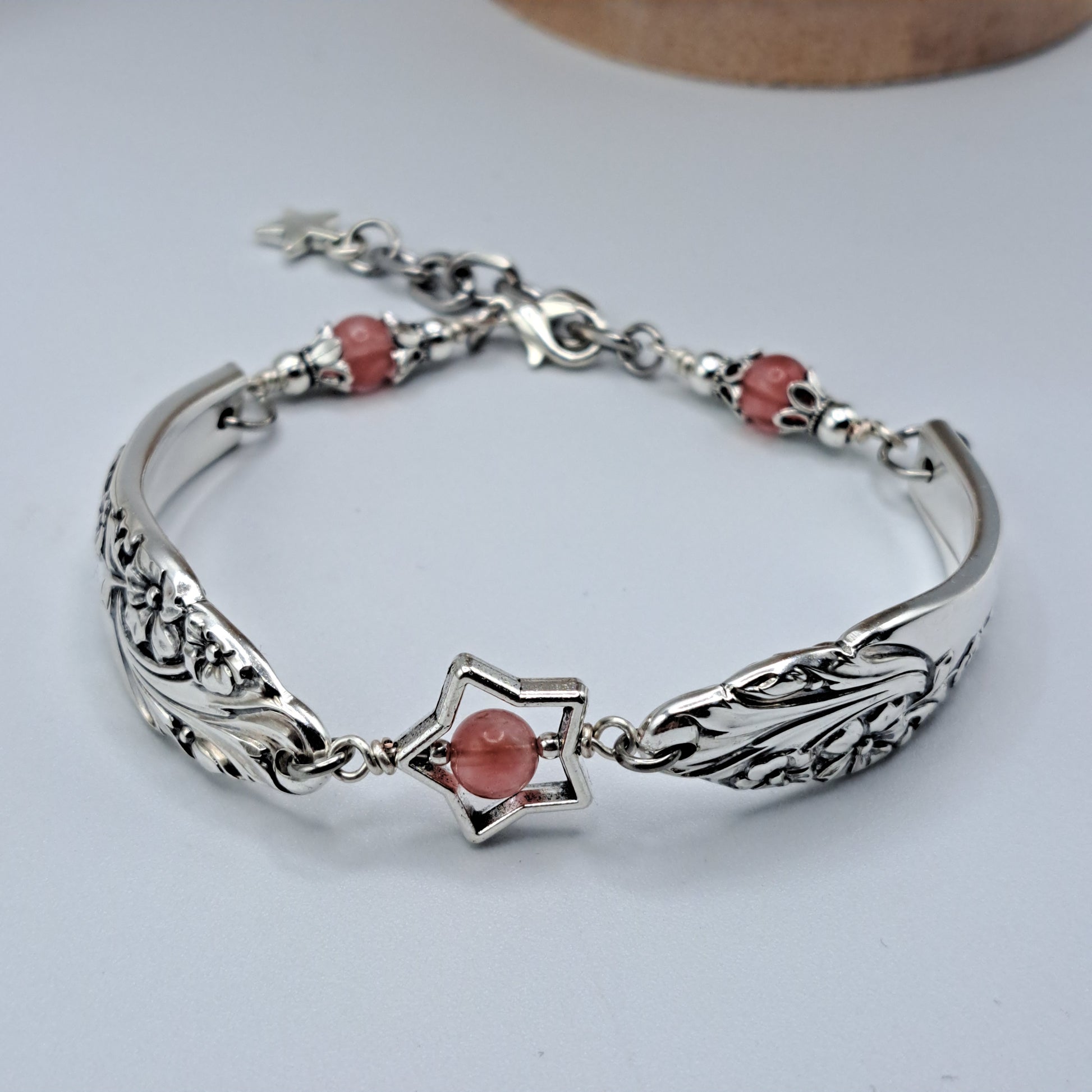 Handmade vintage silverware bracelet made from Evening Star 1950 silverplated handles with center cherry quartz and side beads